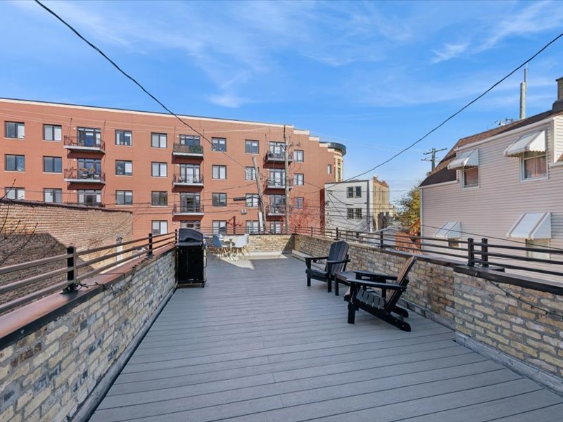 2818 West Fletcher Street, Unit 1 Chicago, IL 60618 - Photo 16 of 18 a balcony with chairs and wooden floor
