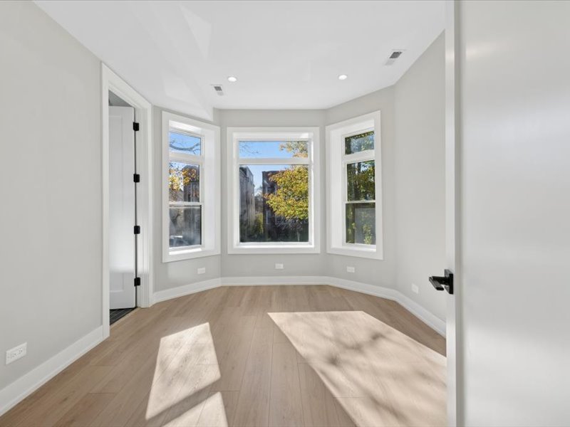 2818 West Fletcher Street, Unit 1 Chicago, IL 60618 - Photo 9 of 18 a spacious bathroom with a tub shower and windows