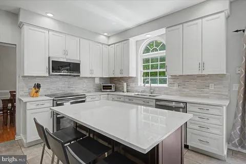 a kitchen with a stove a sink and a microwave