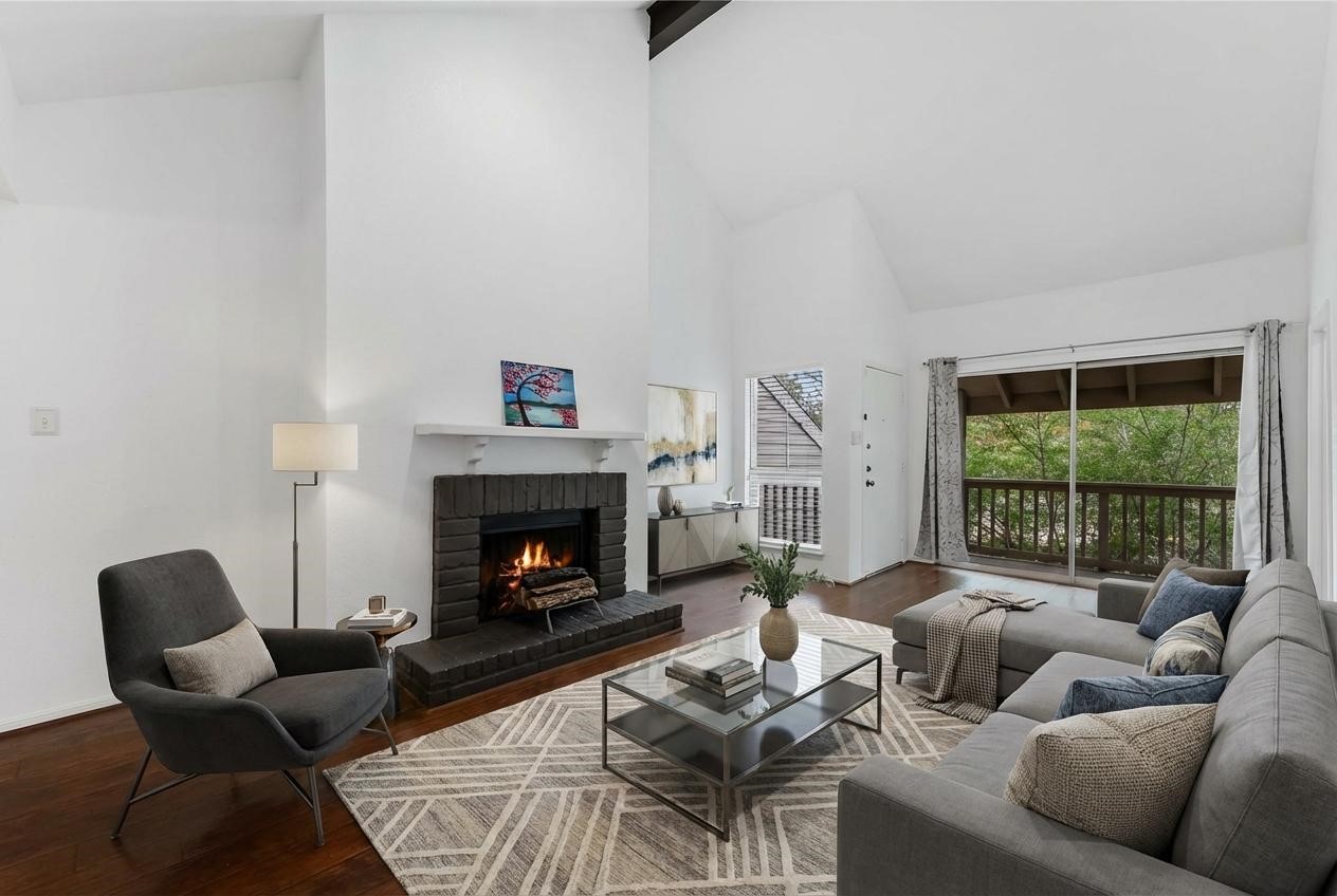 2100 Tanglewilde Street, Unit 330 Houston, TX 77063 - Photo 1 of 22 a living room with furniture and a fireplace