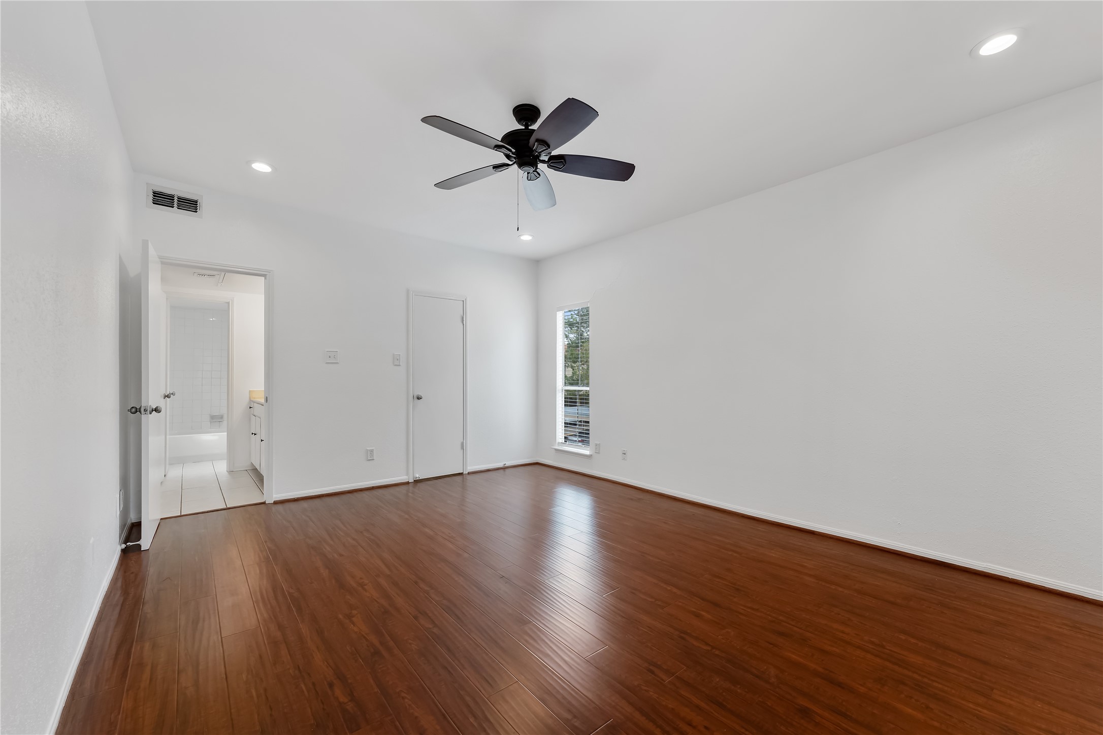 2100 Tanglewilde Street, Unit 330 Houston, TX 77063 - Photo 16 of 22 a view of an empty room with wooden floor