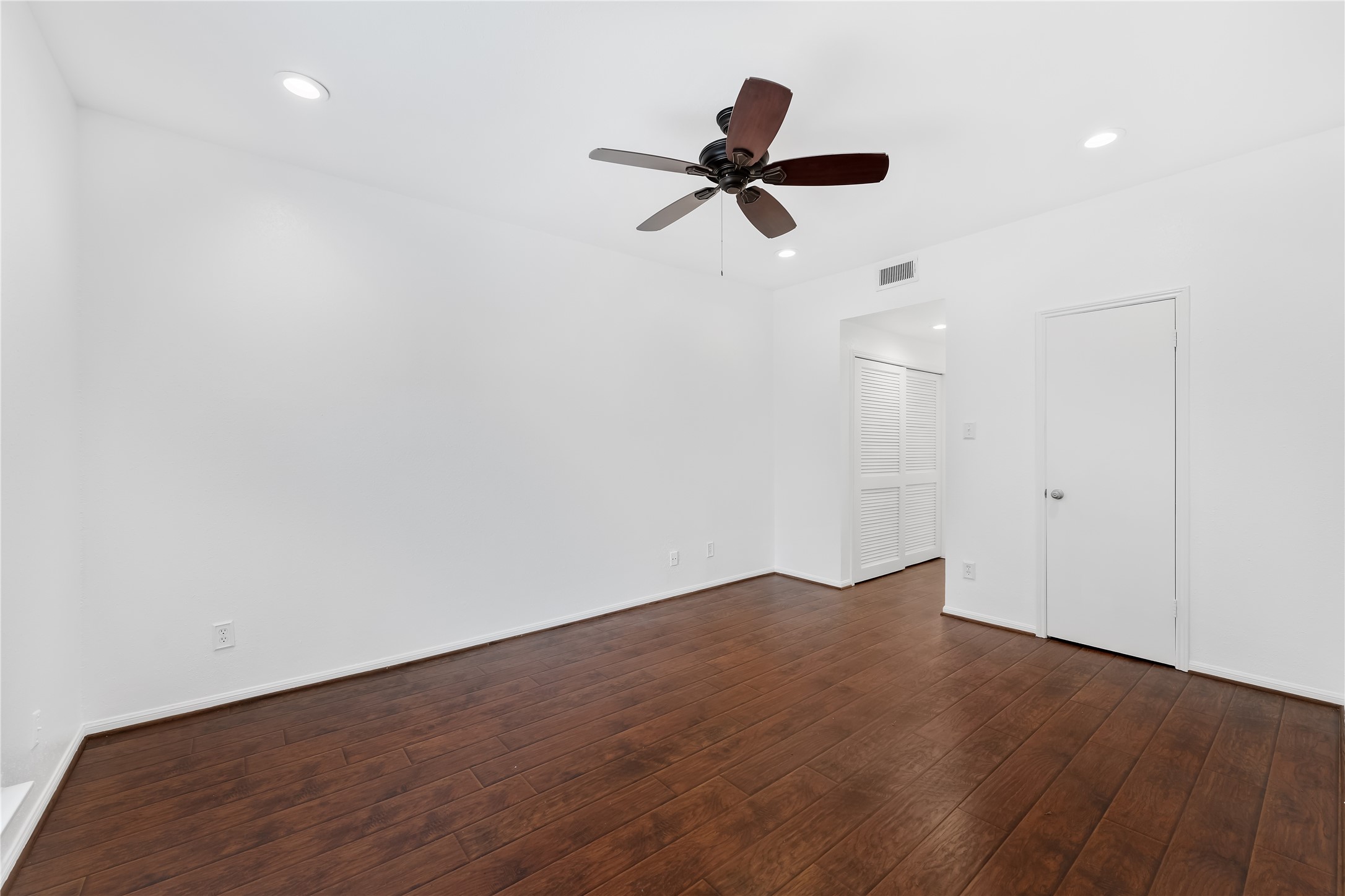 2100 Tanglewilde Street, Unit 330 Houston, TX 77063 - Photo 19 of 22 an empty room with wooden floor closet and windows