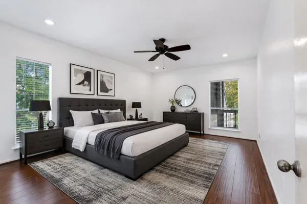 a bedroom with a large bed and a window