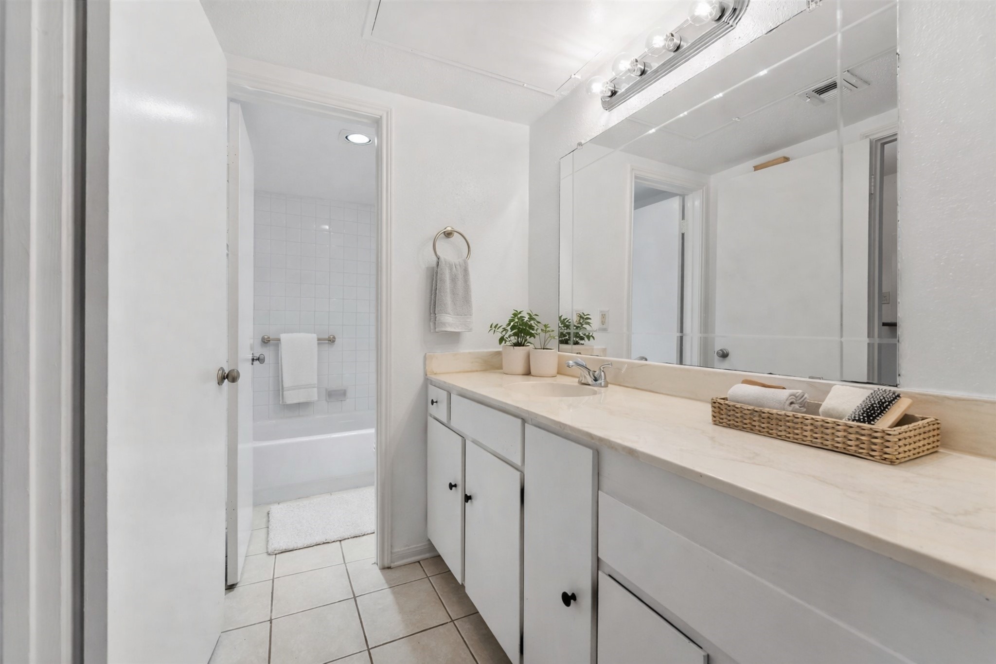 2100 Tanglewilde Street, Unit 330 Houston, TX 77063 - Photo 4 of 22 a bathroom with a double vanity sink mirror and bathtub