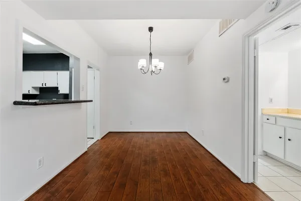 a view of a kitchen with microwave and cabinets