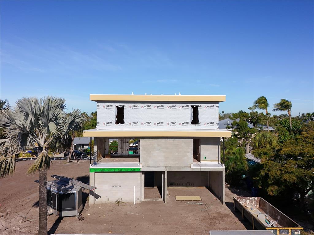 581 Hibiscus Way Longboat Key, FL 34228 - Photo 10 of 12 a front view of a house with a garden