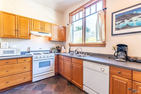 a view of a dining room with furniture and a window