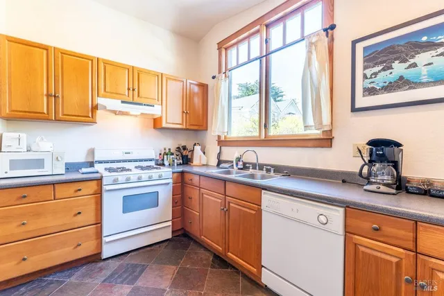 a living room with furniture a flat screen tv and a floor to ceiling window