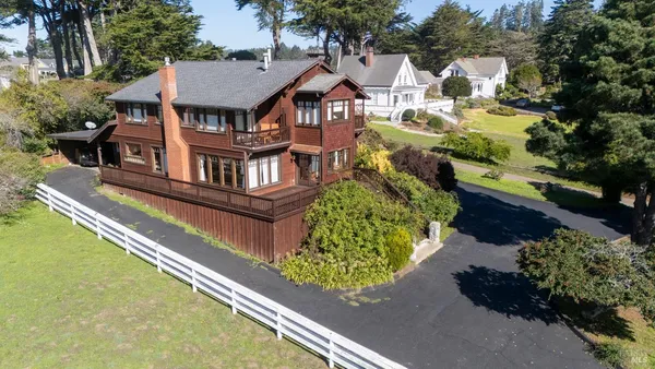 an aerial view of a house with a garden and trees