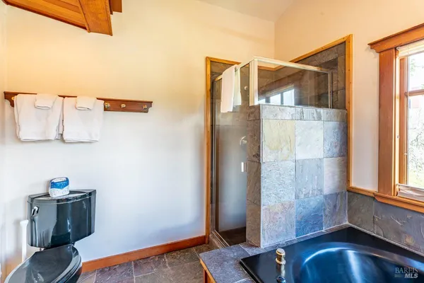 a spacious bedroom with a large bed and a large window