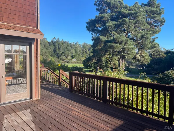 a view of a balcony with wooden floor