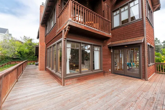 a bed sitting in a bedroom and a flat tv screen on dresser