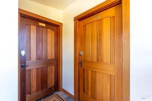 a kitchen with stainless steel appliances granite countertop a sink dishwasher stove and cabinets with wooden floor