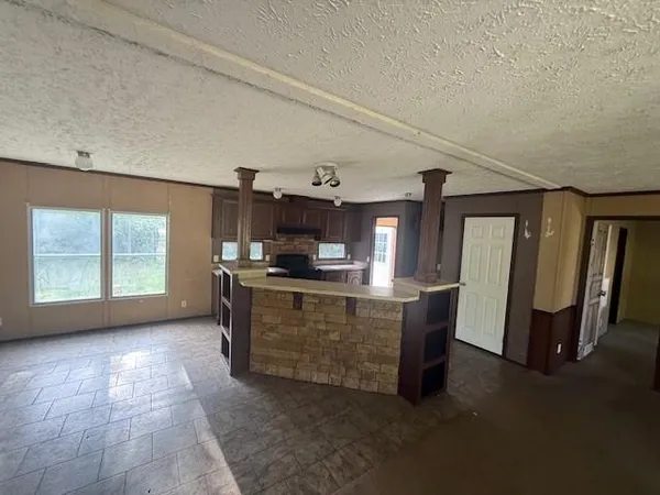 a view of kitchen with furniture and window