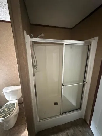 a bathroom with a glass door shower