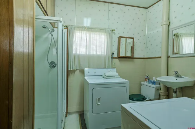 a bathroom with a sink a toilet and mirror