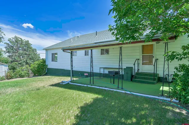 a backyard of a house with plants and tree