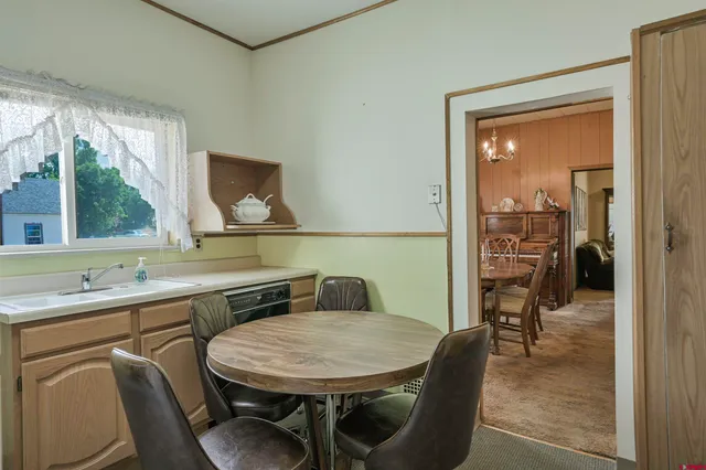 a dining room with furniture and a window