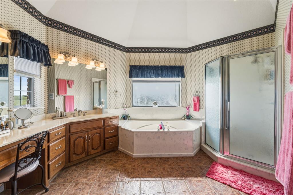130 Blazek Road Alma, TX 75119 - Photo 18 of 34 a spacious bathroom with a tub sink and mirror