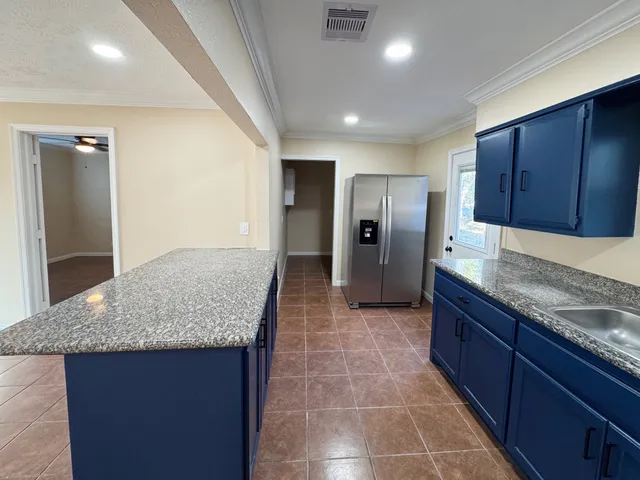 a kitchen with stainless steel appliances granite countertop a sink and cabinets