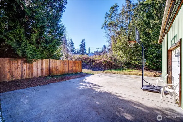 a view of a backyard with wooden fence