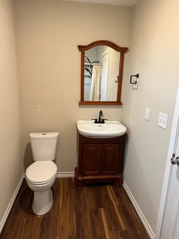 a bathroom with a toilet sink and a mirror