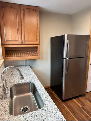 a kitchen with a refrigerator and a sink