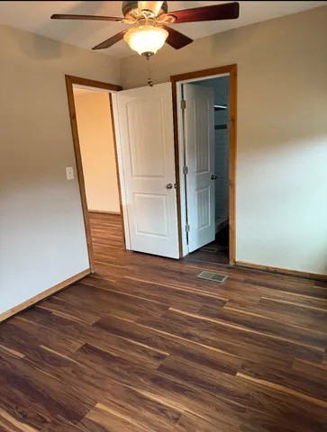 a view of a room with wooden floor and staircase