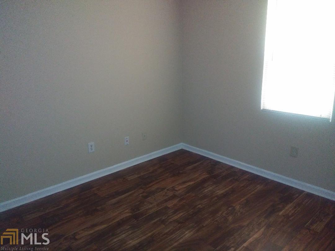 82 Paris Circle, Unit A Hiram, GA 30141 - Photo 11 of 12 a view of an empty room with wooden floor and a window