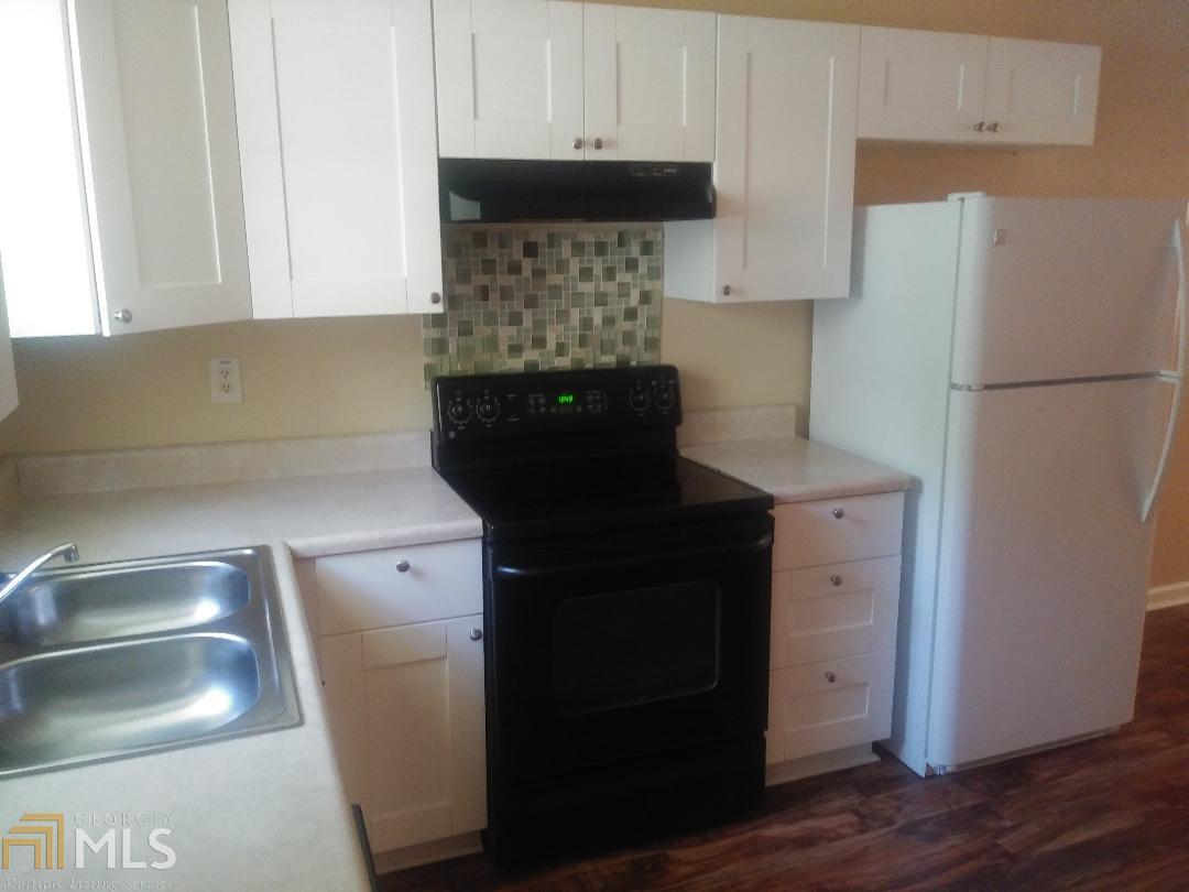 82 Paris Circle, Unit A Hiram, GA 30141 - Photo 12 of 12 a kitchen with a refrigerator and a sink