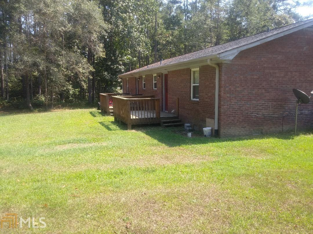82 Paris Circle, Unit A Hiram, GA 30141 - Photo 2 of 12 a backyard of a house with wooden fence and large trees