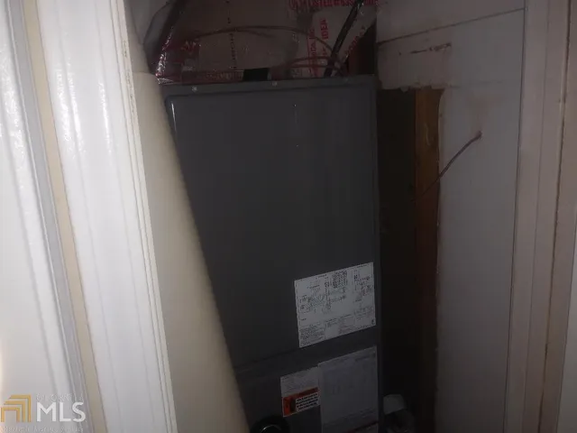 a view of a kitchen with wooden floor and electronic appliances