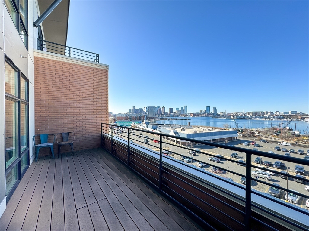 a view of a balcony with wooden floor and city view