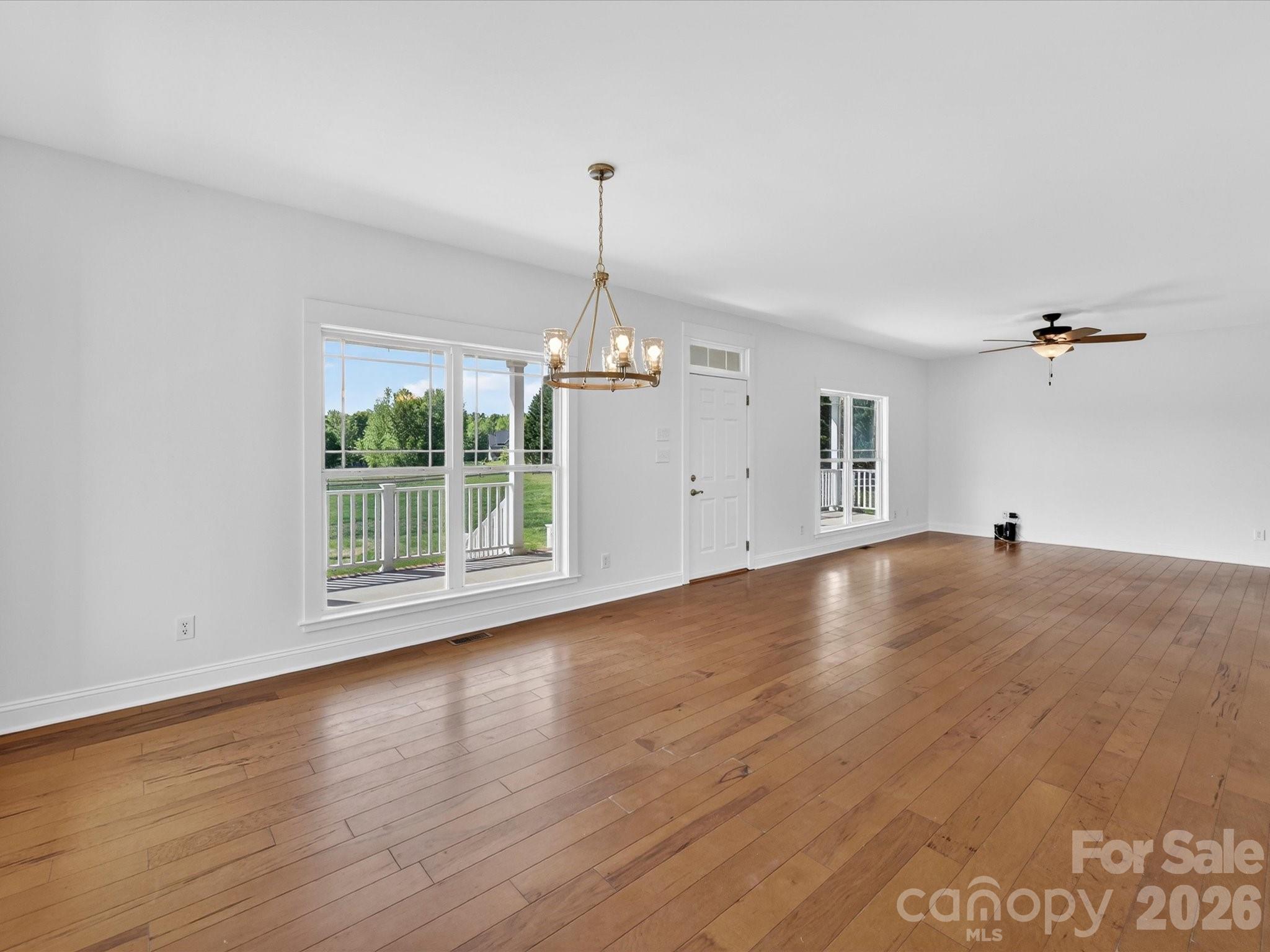 4566 Little Mountain Road Catawba, NC 28609 - Photo 23 of 47 an empty room with wooden floor and windows