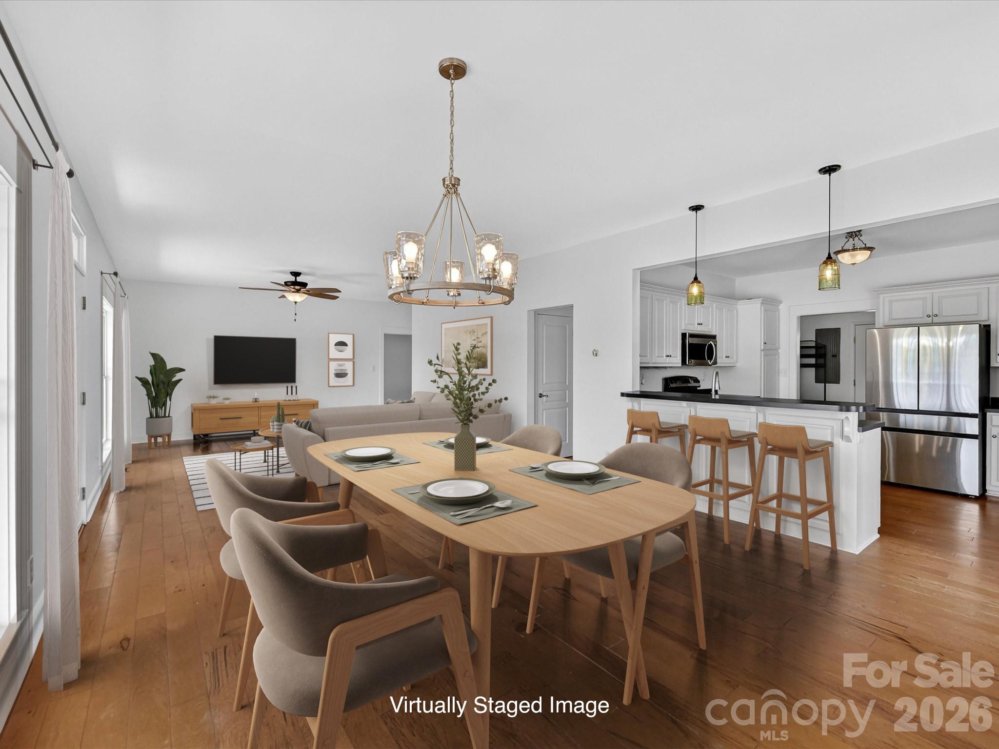 4566 Little Mountain Road Catawba, NC 28609 - Photo 27 of 47 a view of a dining room and livingroom with furniture wooden floor a chandelier