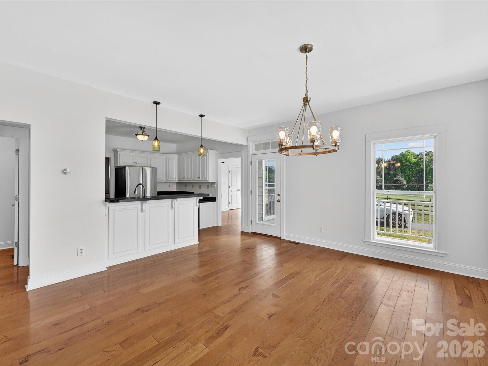 4566 Little Mountain Road Catawba, NC 28609 - Photo 29 of 47 a view of a kitchen with an empty space and a wooden floor