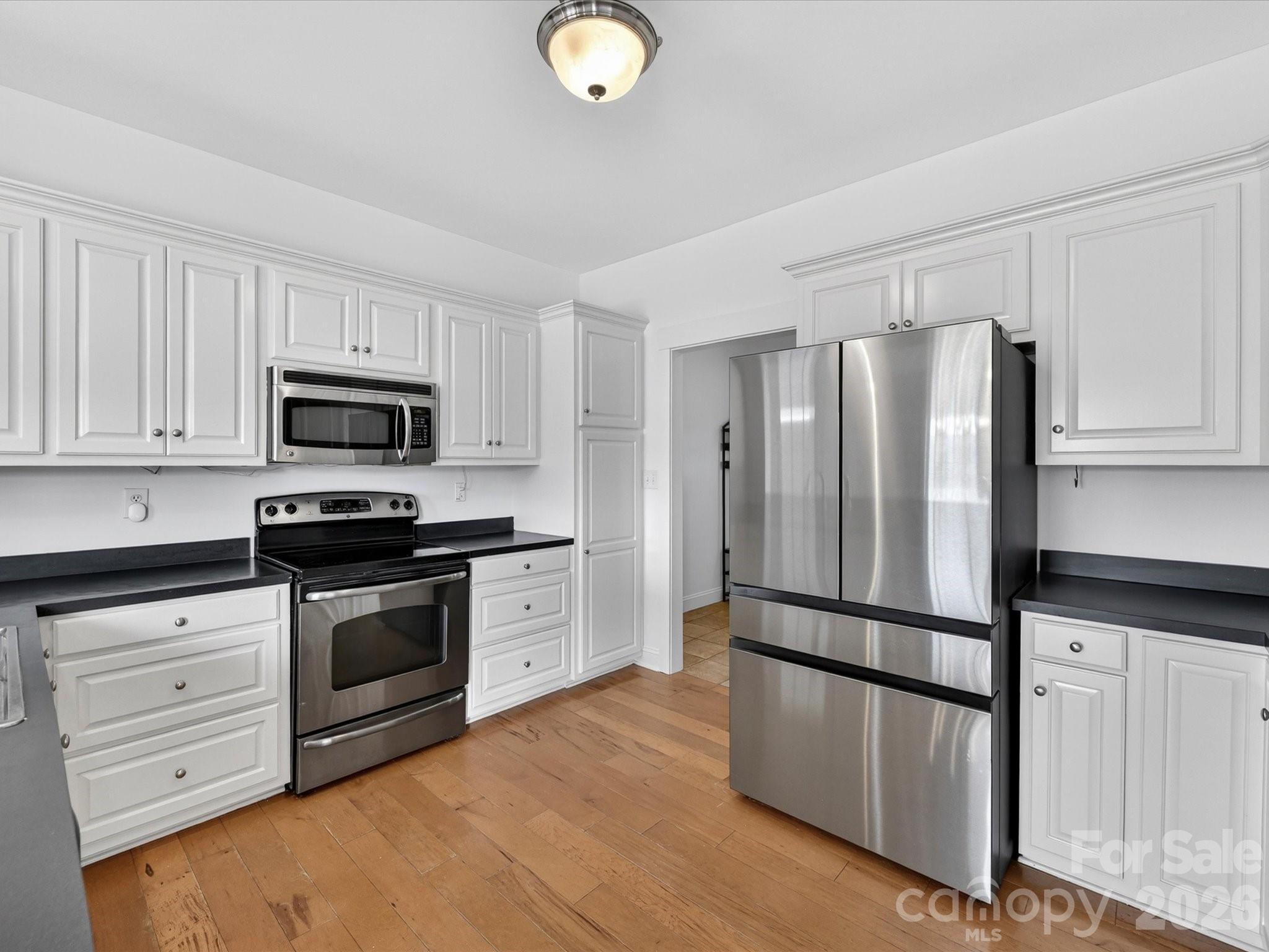 4566 Little Mountain Road Catawba, NC 28609 - Photo 31 of 47 a kitchen with stainless steel appliances granite countertop a refrigerator microwave and sink