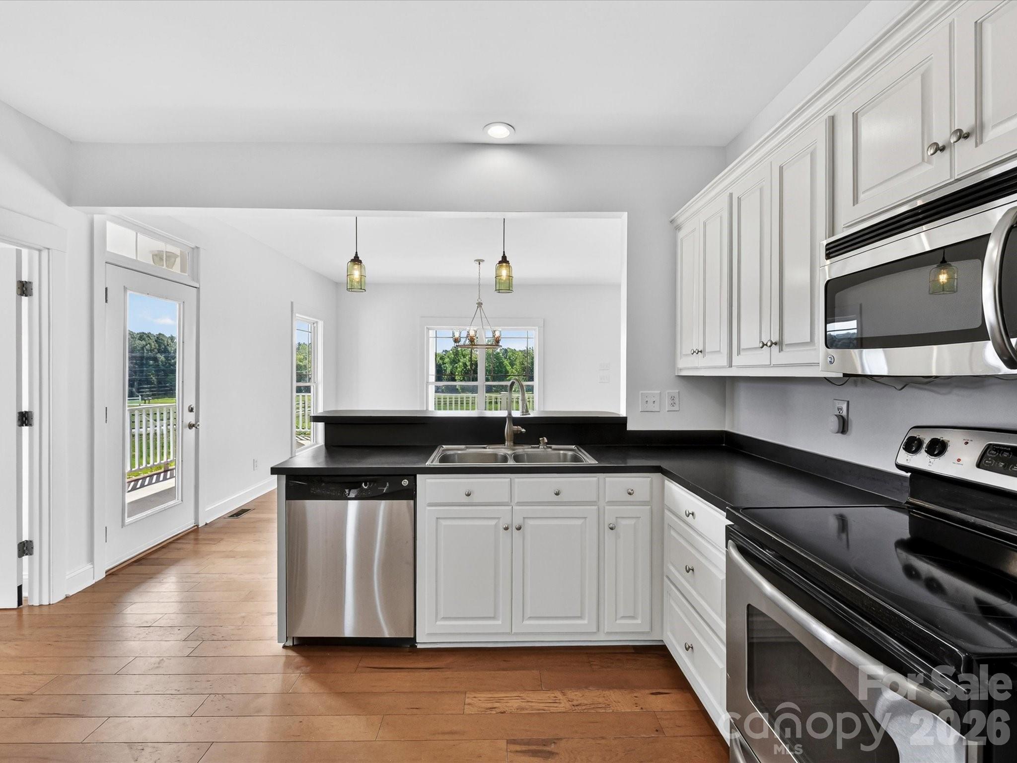 4566 Little Mountain Road Catawba, NC 28609 - Photo 32 of 47 a kitchen with stainless steel appliances a sink a stove and cabinets