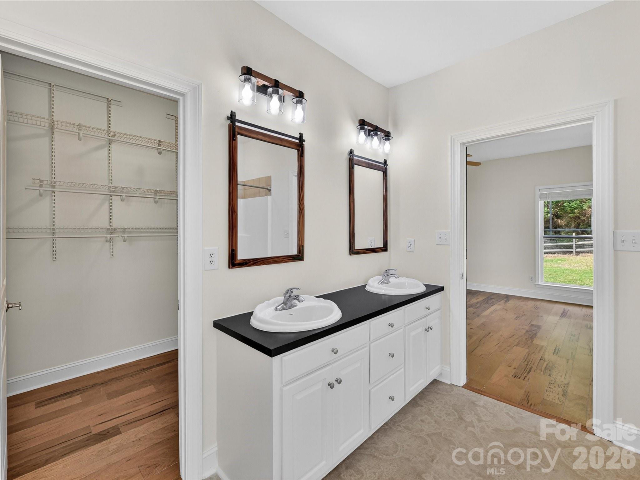 4566 Little Mountain Road Catawba, NC 28609 - Photo 36 of 47 a bathroom with double sink and a mirror
