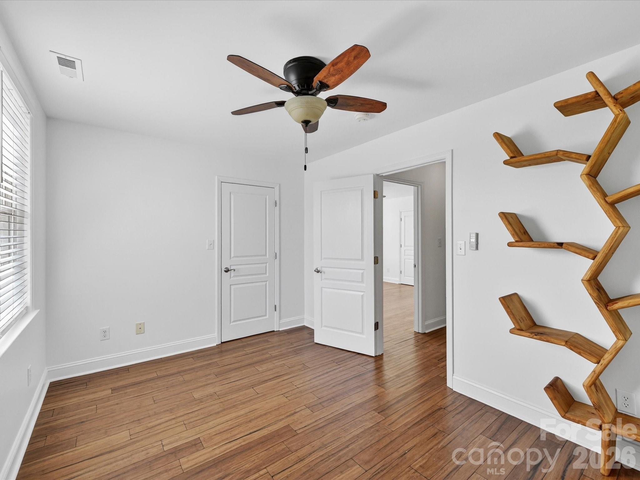 4566 Little Mountain Road Catawba, NC 28609 - Photo 44 of 47 a view of empty room with wooden floor and fan