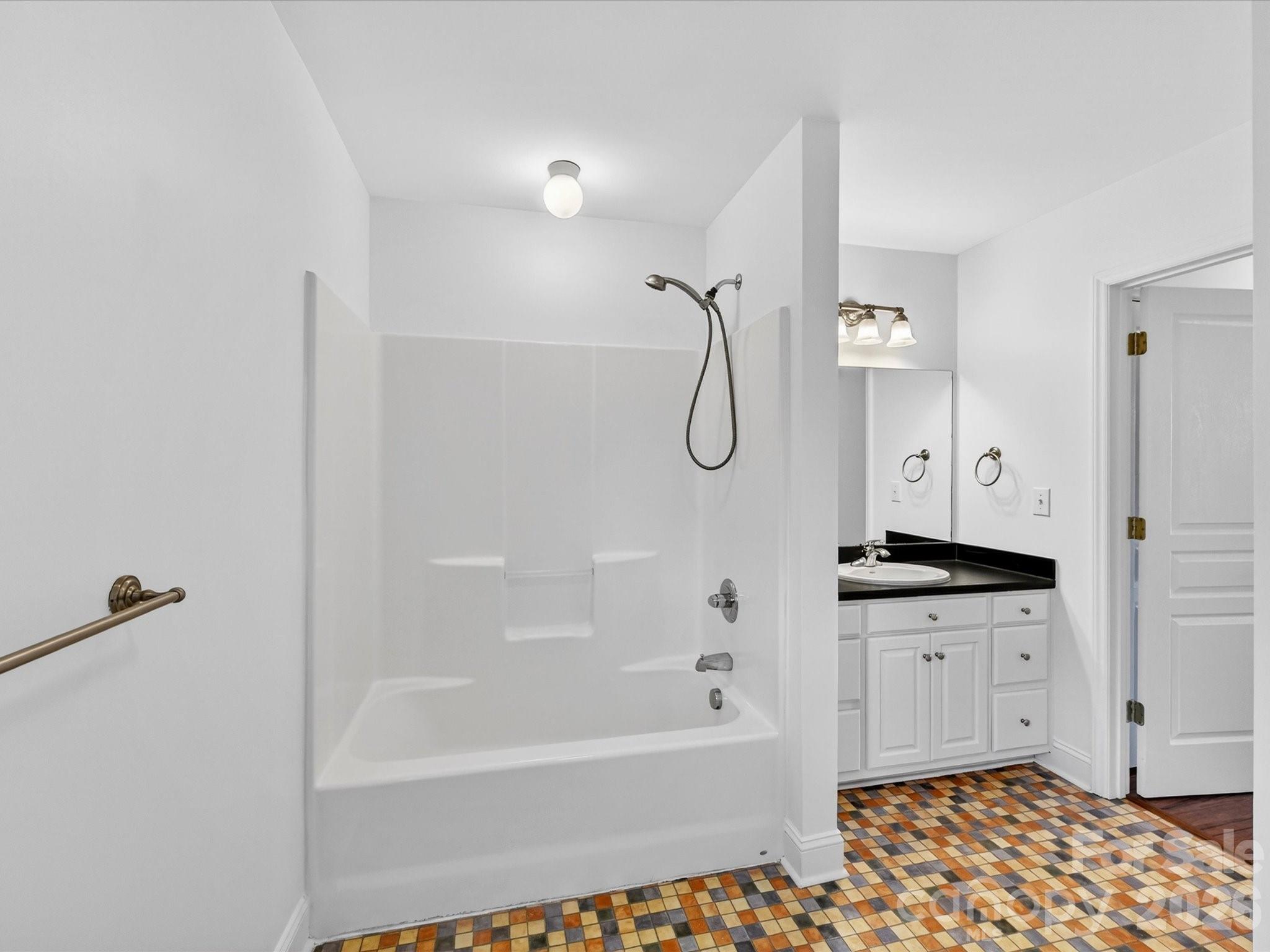 4566 Little Mountain Road Catawba, NC 28609 - Photo 45 of 47 a bathroom with a granite countertop sink a mirror and a bathtub