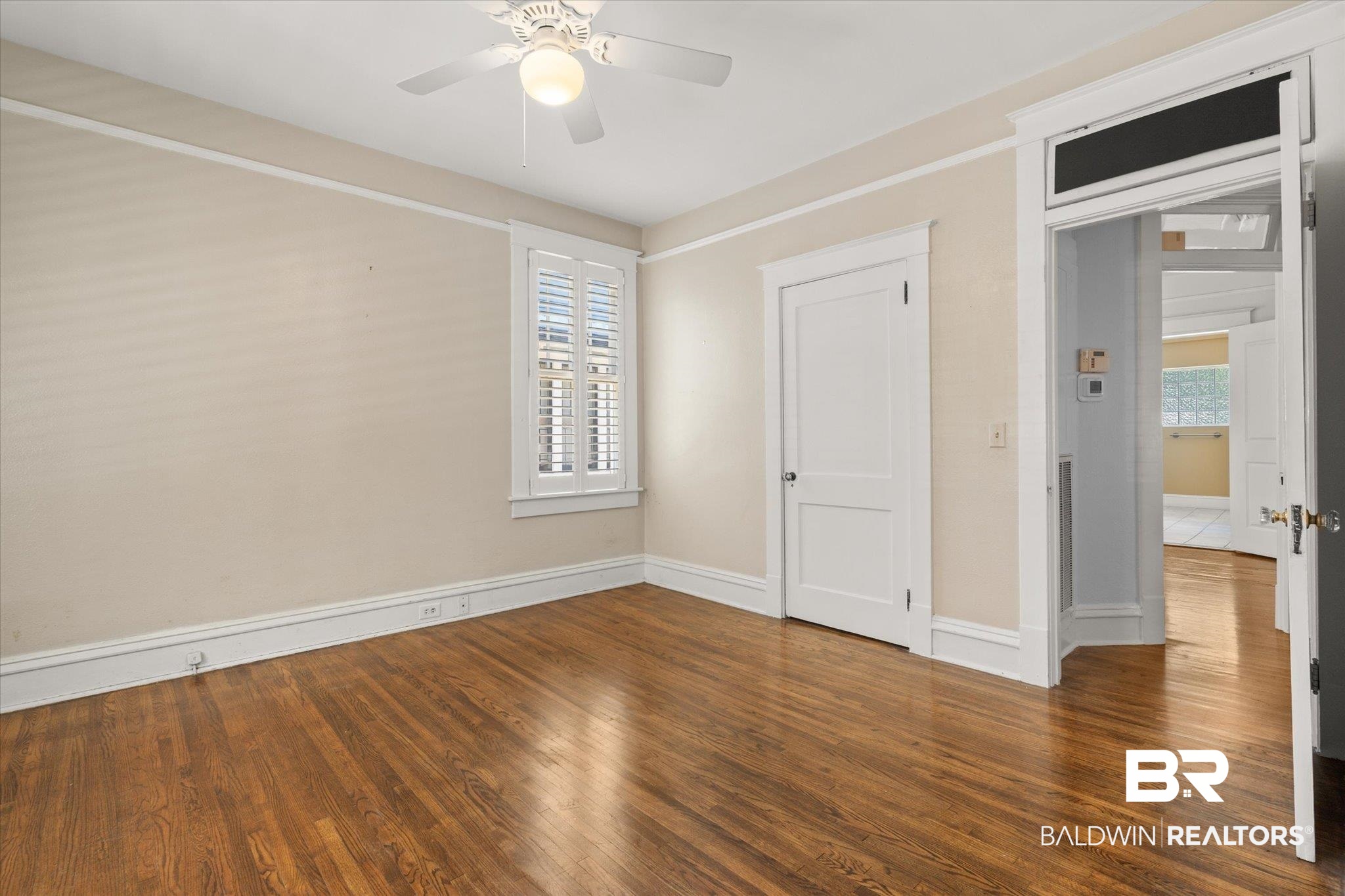 24 Macy Place Mobile, AL 36604 - Photo 17 of 38 Unfurnished bedroom featuring wood finished floors, baseboards, and a ceiling fan
