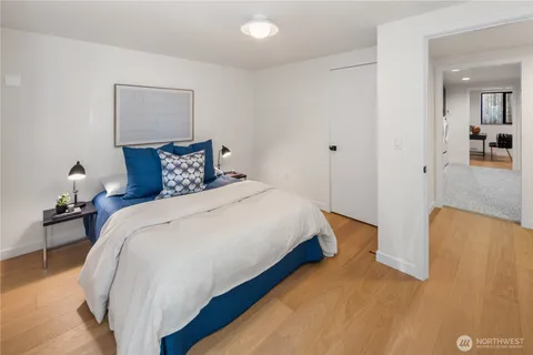 a bedroom with bed and a night stand