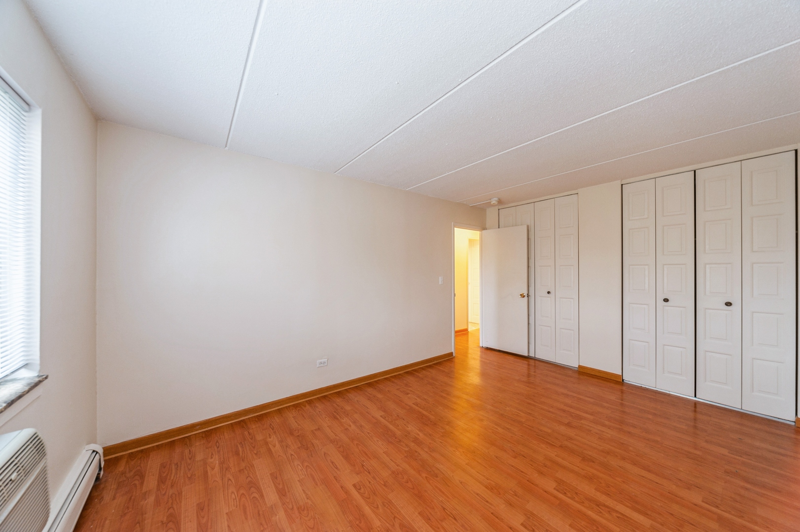 577 Fairway View Drive, Unit 2L Wheeling, IL 60090 - Photo 11 of 15 a view of an empty room with wooden floor