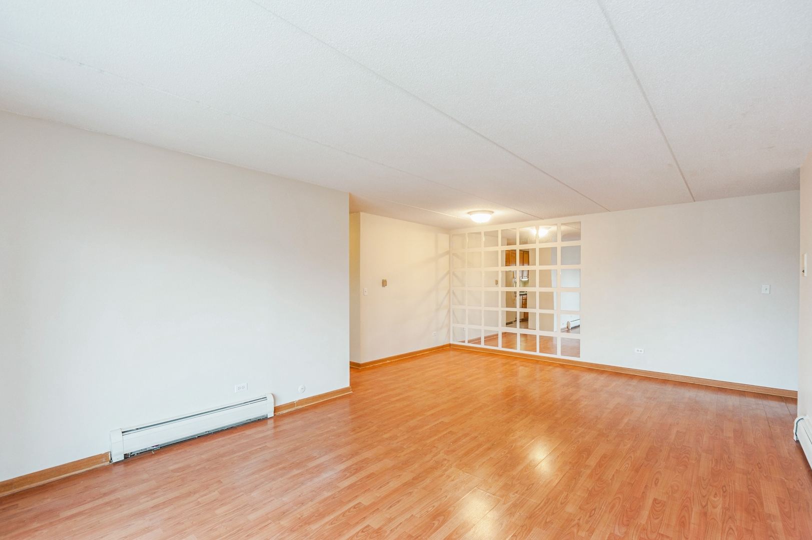 577 Fairway View Drive, Unit 2L Wheeling, IL 60090 - Photo 4 of 15 a view of an empty room with wooden floor