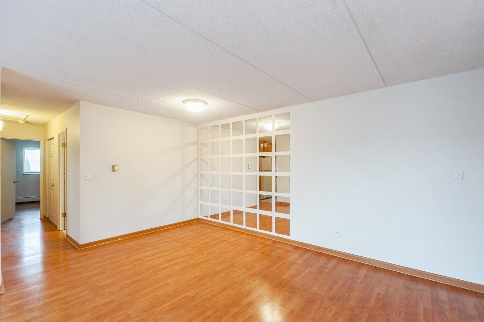 577 Fairway View Drive, Unit 2L Wheeling, IL 60090 - Photo 5 of 15 wooden floor in an empty room with a window