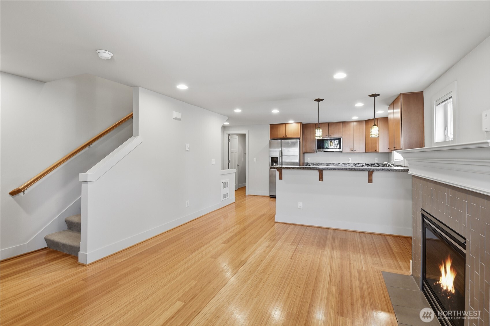 723 North 95th Street, Unit A Seattle, WA 98103 - Photo 12 of 20 a view of kitchen with wooden floor and electronic appliances