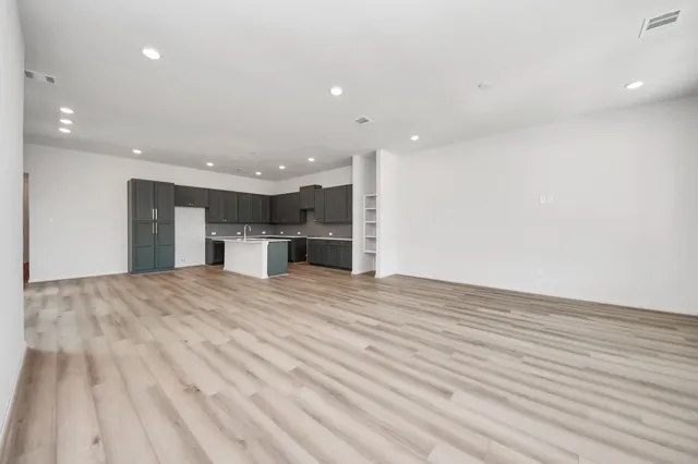 a view of kitchen with refrigerator and wooden floor