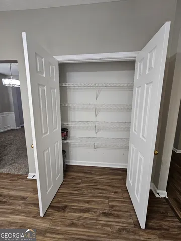 a view of a room with wooden floor
