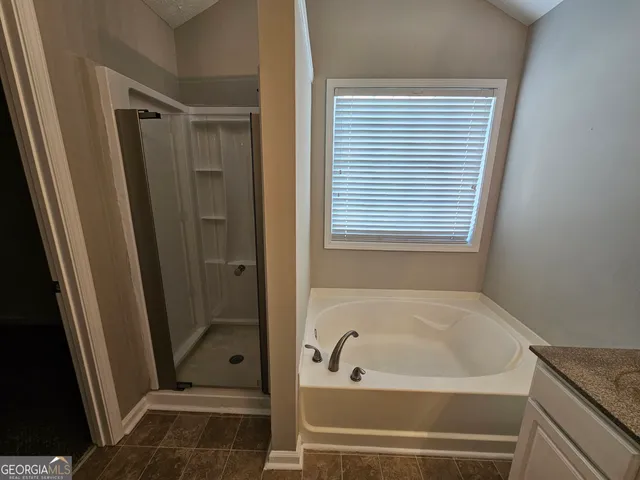 a bathroom with a tub and a shower